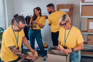 Group of volunteers working in community charity donation center